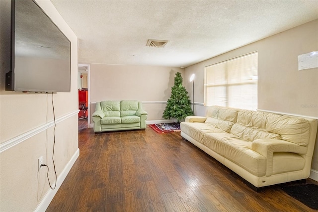 9020 Gray Fox Ln, Port Richey, FL 34668 - living area featuring dark wood-style floors, baseboards, and a textured ceiling