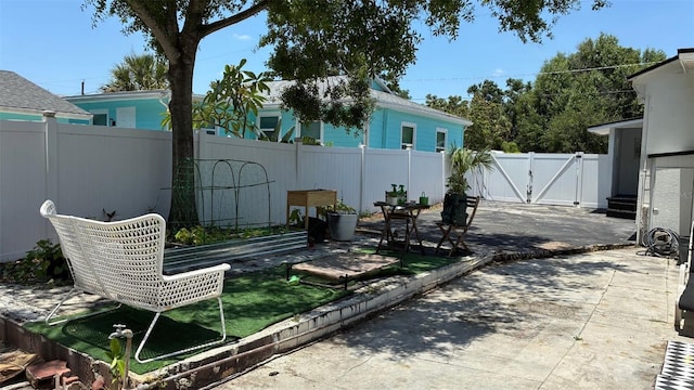 2219 Thrace St, Tampa, FL 33605 - view of patio featuring a gate and a vegetable garden