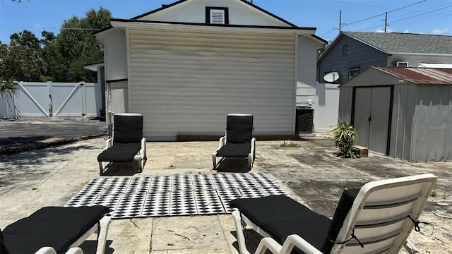 2219 Thrace St, Tampa, FL 33605 - rear view of property with a patio and a gate
