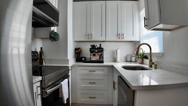 2219 Thrace St, Tampa, FL 33605 - kitchen featuring black appliances, a sink, light stone countertops, and white cabinets