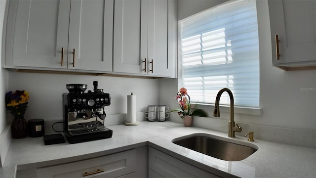 2219 Thrace St, Tampa, FL 33605 - kitchen featuring a sink, light stone countertops, and white cabinets