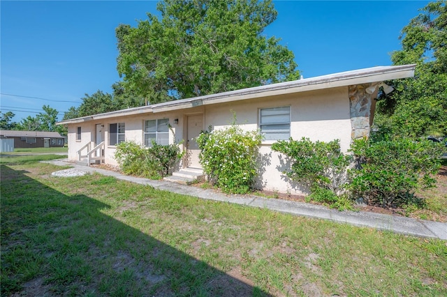 725 2nd Ave NE, Largo, FL 33770 - view of front of home featuring stucco siding and a front lawn