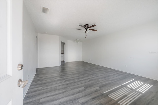 725 2nd Ave NE, Largo, FL 33770 - empty room featuring a ceiling fan, wood finished floors, and baseboards