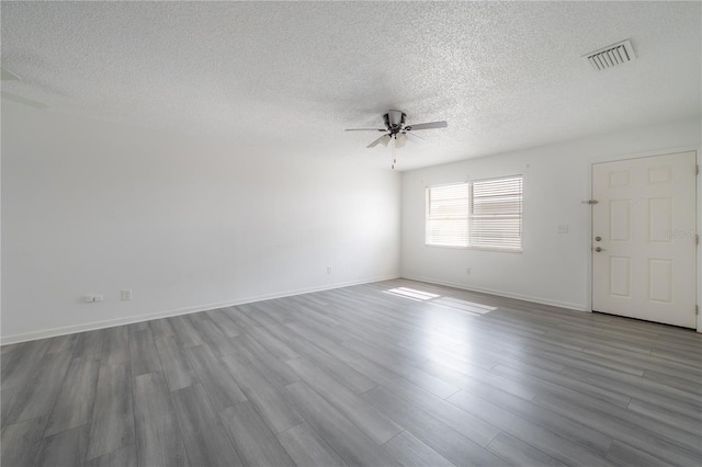 725 2nd Ave NE, Largo, FL 33770 - spare room with ceiling fan, a textured ceiling, wood finished floors, and baseboards