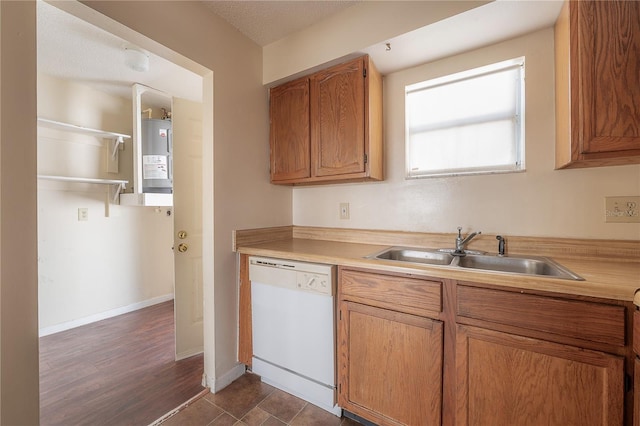 725 2nd Ave NE, Largo, FL 33770 - kitchen featuring white dishwasher, a sink, light countertops, electric water heater, and baseboards