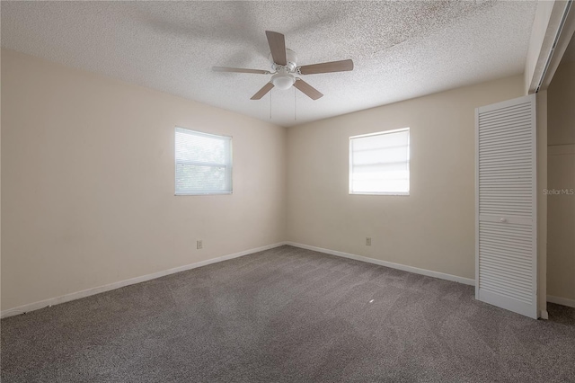 725 2nd Ave NE, Largo, FL 33770 - unfurnished bedroom featuring carpet flooring, a textured ceiling, baseboards, ceiling fan, and a closet