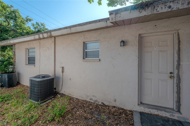 725 2nd Ave NE, Largo, FL 33770 - entrance to property with central air condition unit and stucco siding