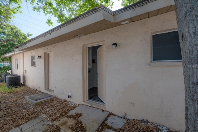 725 2nd Ave NE, Largo, FL 33770 - property entrance featuring stucco siding and central air condition unit