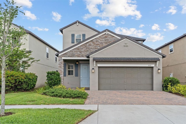 4345 Cadence Loop, Land O Lakes, FL 34638 - traditional-style house featuring stucco siding, decorative driveway, an attached garage, stone siding, and a front lawn