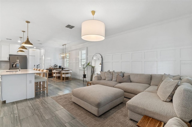 4345 Cadence Loop, Land O Lakes, FL 34638 - living room featuring a decorative wall and crown molding