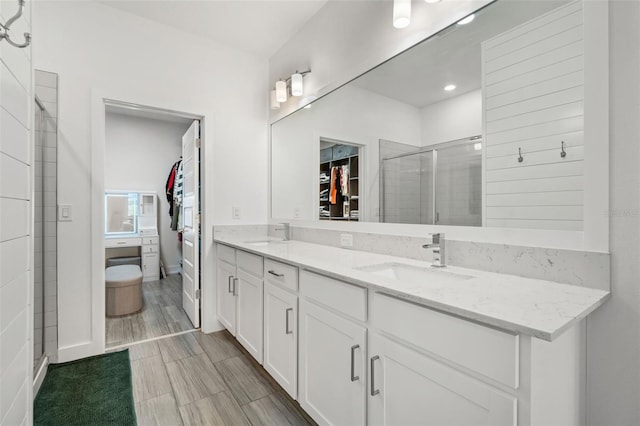 4345 Cadence Loop, Land O Lakes, FL 34638 - bathroom with a walk in closet, double vanity, and a stall shower