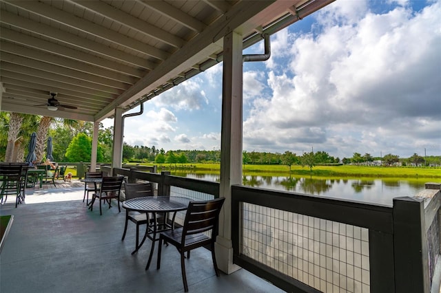 4345 Cadence Loop, Land O Lakes, FL 34638 - balcony featuring a water view, outdoor dining area, view of wooded area, and a ceiling fan