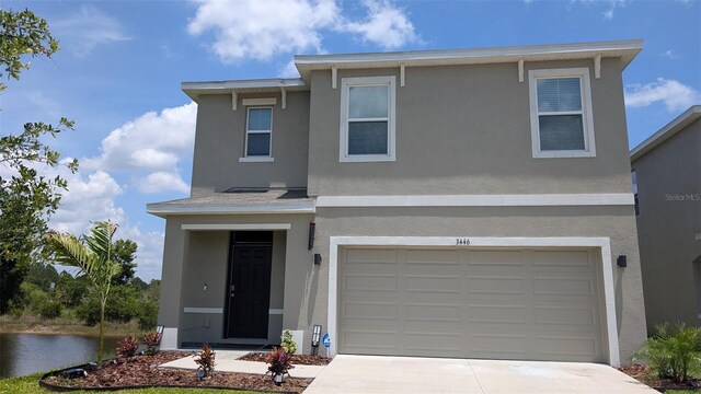 3446 Suncoast Plains Dr, Odessa, FL 33556 - view of front of home with stucco siding, a garage, and driveway