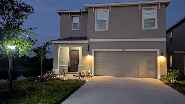 3446 Suncoast Plains Dr, Odessa, FL 33556 - view of front of home with stucco siding, concrete driveway, and an attached garage