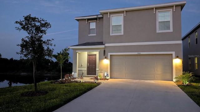 3446 Suncoast Plains Dr, Odessa, FL 33556 - traditional home with stucco siding, driveway, a garage, and a water view