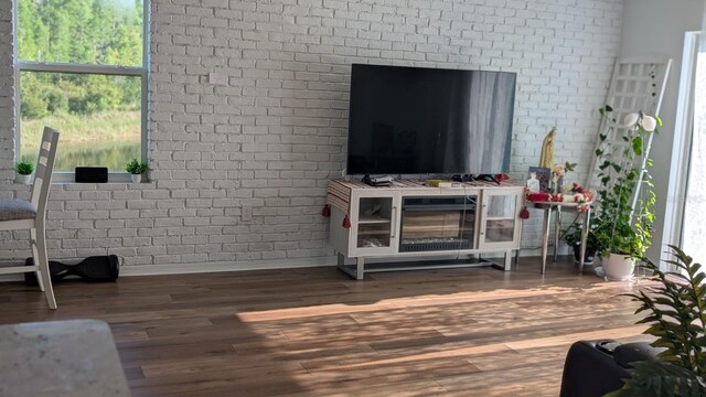 3446 Suncoast Plains Dr, Odessa, FL 33556 - living room featuring baseboards, wood finished floors, and brick wall