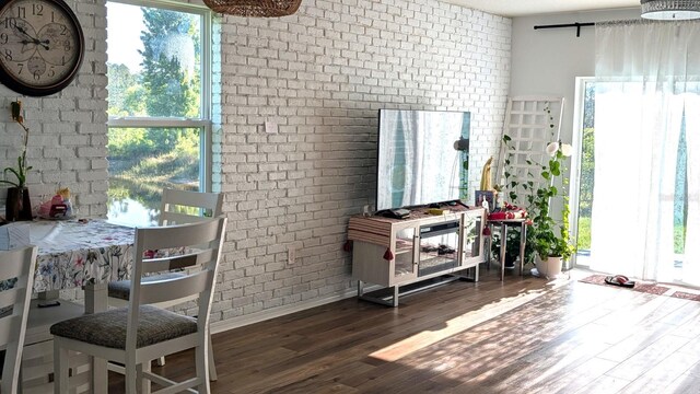 3446 Suncoast Plains Dr, Odessa, FL 33556 - interior space featuring brick wall, wood finished floors, and baseboards
