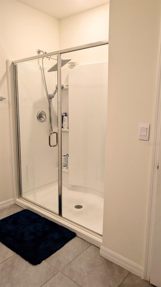 3446 Suncoast Plains Dr, Odessa, FL 33556 - full bath with a shower stall, tile patterned floors, and baseboards