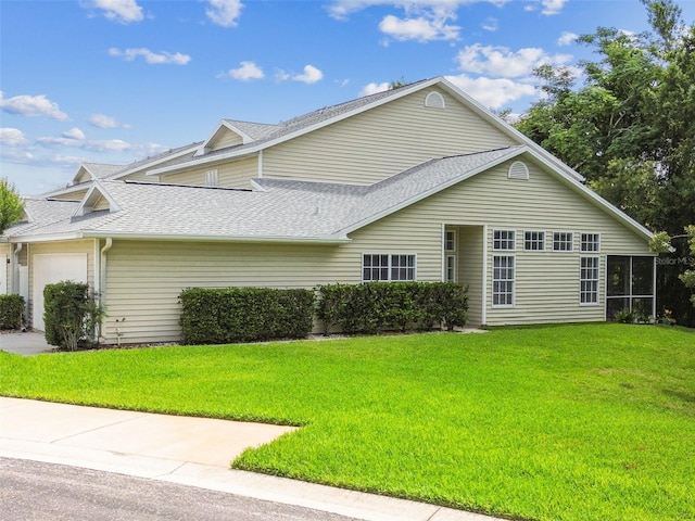 1624 Lullwater Ln, Lutz, FL 33549 - view of side of property with an attached garage, a shingled roof, and a yard