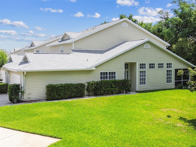 1624 Lullwater Ln, Lutz, FL 33549 - view of front facade featuring a front lawn, an attached garage, and roof with shingles