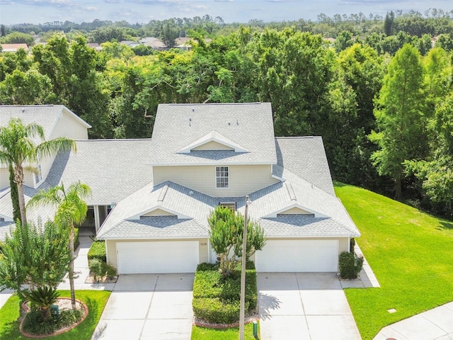 1624 Lullwater Ln, Lutz, FL 33549 - view of front of house with roof with shingles, driveway, a front lawn, and an attached garage