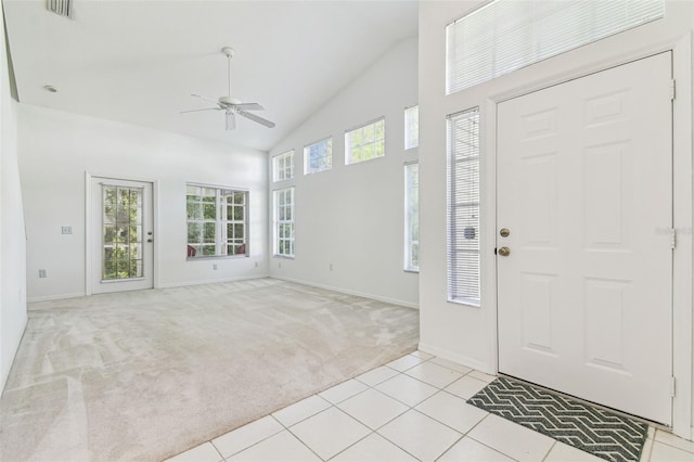 1624 Lullwater Ln, Lutz, FL 33549 - foyer entrance with a ceiling fan, light colored carpet, high vaulted ceiling, baseboards, and light tile patterned flooring