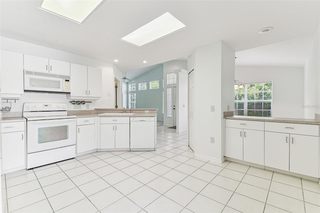 1624 Lullwater Ln, Lutz, FL 33549 - kitchen with white appliances, a peninsula, white cabinetry, light countertops, and recessed lighting