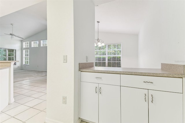 1624 Lullwater Ln, Lutz, FL 33549 - kitchen with lofted ceiling, a ceiling fan, a chandelier, light countertops, and white cabinets