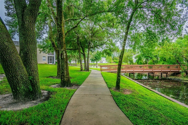 1624 Lullwater Ln, Lutz, FL 33549 - view of home's community featuring a lawn and a deck with water view