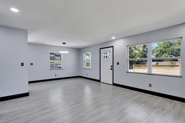 8603 N 9th St, Tampa, FL 33604 - unfurnished living room with baseboards, recessed lighting, and light wood-type flooring