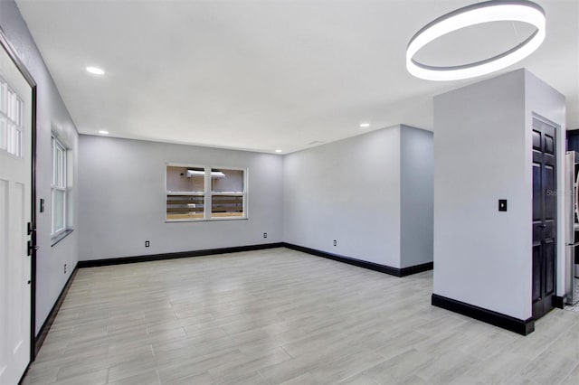 8603 N 9th St, Tampa, FL 33604 - empty room featuring light wood finished floors, recessed lighting, and baseboards