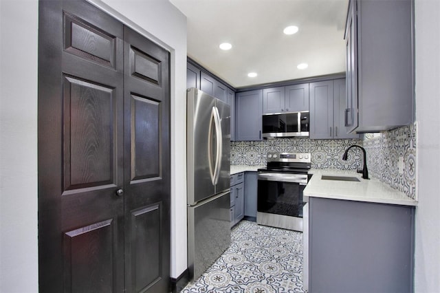 8603 N 9th St, Tampa, FL 33604 - kitchen with appliances with stainless steel finishes, a sink, decorative backsplash, light countertops, and recessed lighting