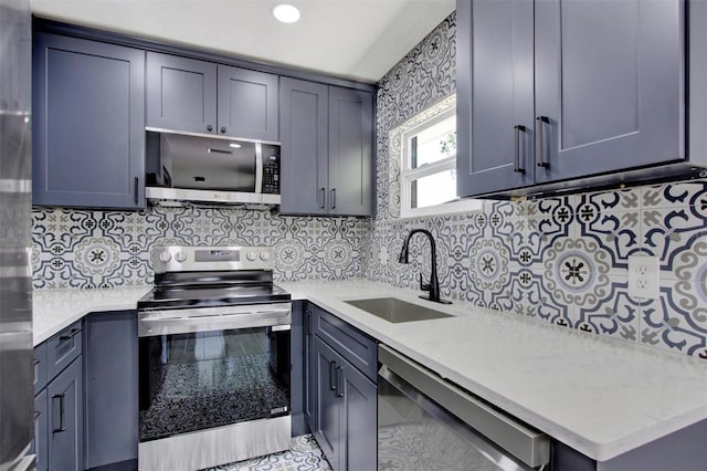8603 N 9th St, Tampa, FL 33604 - kitchen with appliances with stainless steel finishes, a sink, decorative backsplash, and gray cabinets