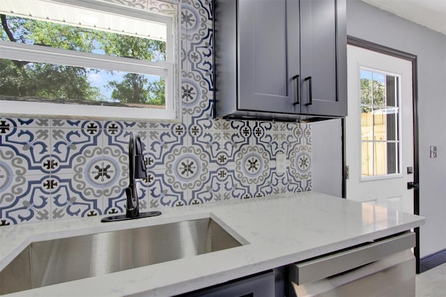 8603 N 9th St, Tampa, FL 33604 - kitchen featuring a sink, light stone countertops, and backsplash