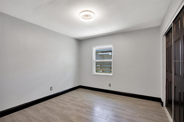 8603 N 9th St, Tampa, FL 33604 - unfurnished bedroom with light wood-style floors and baseboards