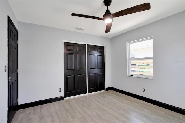 8603 N 9th St, Tampa, FL 33604 - unfurnished bedroom featuring baseboards, light wood-style floors, a closet, and a ceiling fan