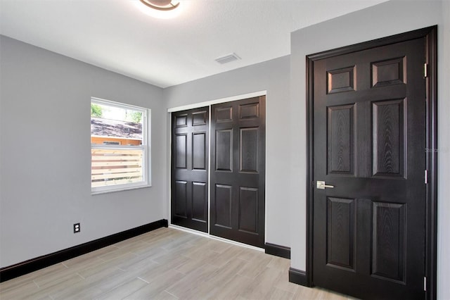 8603 N 9th St, Tampa, FL 33604 - unfurnished bedroom featuring baseboards, a closet, and light wood finished floors
