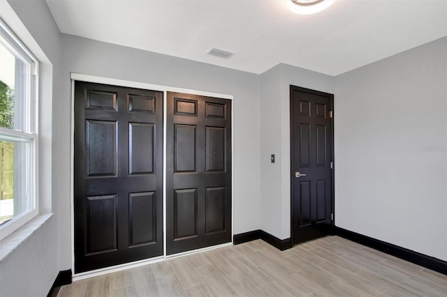 8603 N 9th St, Tampa, FL 33604 - foyer entrance with baseboards and light wood finished floors