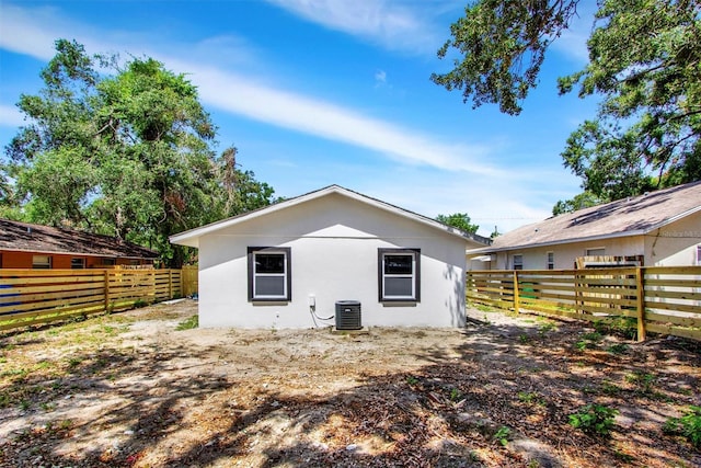 8603 N 9th St, Tampa, FL 33604 - back of property featuring central air condition unit, stucco siding, and a fenced backyard