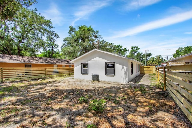 8603 N 9th St, Tampa, FL 33604 - rear view of property featuring a fenced backyard, stucco siding, and cooling unit