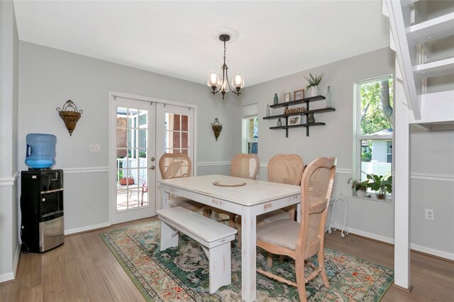 2311 64th Street Ct W, Bradenton, FL 34209 - dining room with a chandelier, light wood-type flooring, french doors, and baseboards