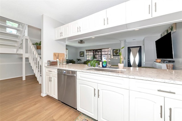 2311 64th Street Ct W, Bradenton, FL 34209 - kitchen with dishwasher, light wood-style flooring, and light stone countertops