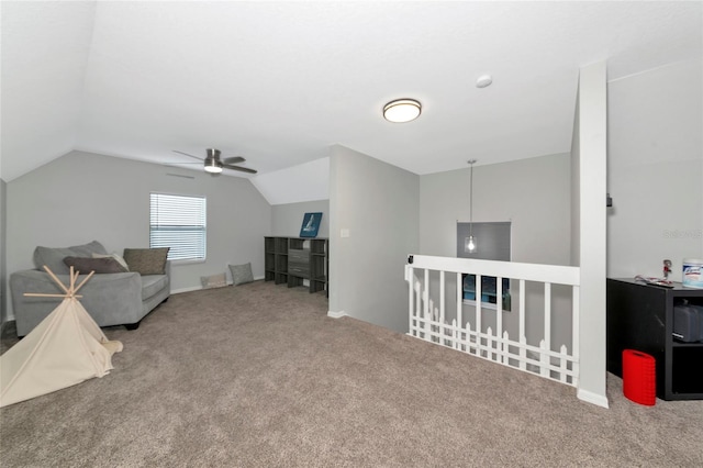 2311 64th Street Ct W, Bradenton, FL 34209 - living area with carpet flooring, vaulted ceiling, ceiling fan, and an upstairs landing