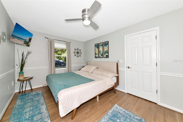 2311 64th Street Ct W, Bradenton, FL 34209 - bedroom with wood finished floors, baseboards, and a ceiling fan