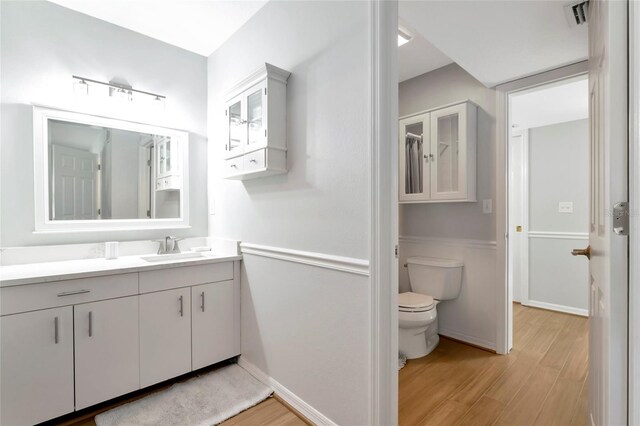 2311 64th Street Ct W, Bradenton, FL 34209 - bathroom featuring wood finished floors, toilet, and vanity