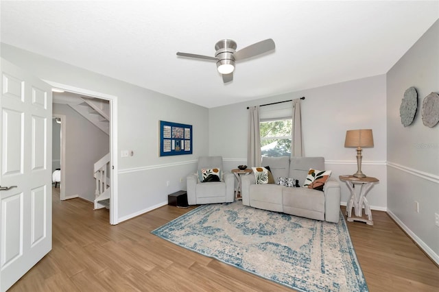 2311 64th Street Ct W, Bradenton, FL 34209 - living room featuring stairs, light wood finished floors, a ceiling fan, and baseboards