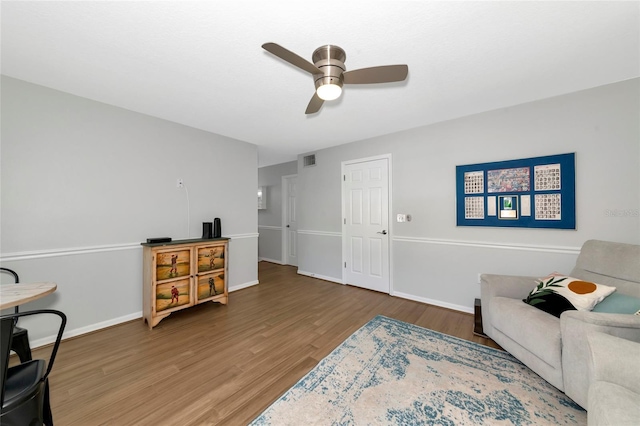 2311 64th Street Ct W, Bradenton, FL 34209 - living room featuring wood finished floors, a ceiling fan, and baseboards