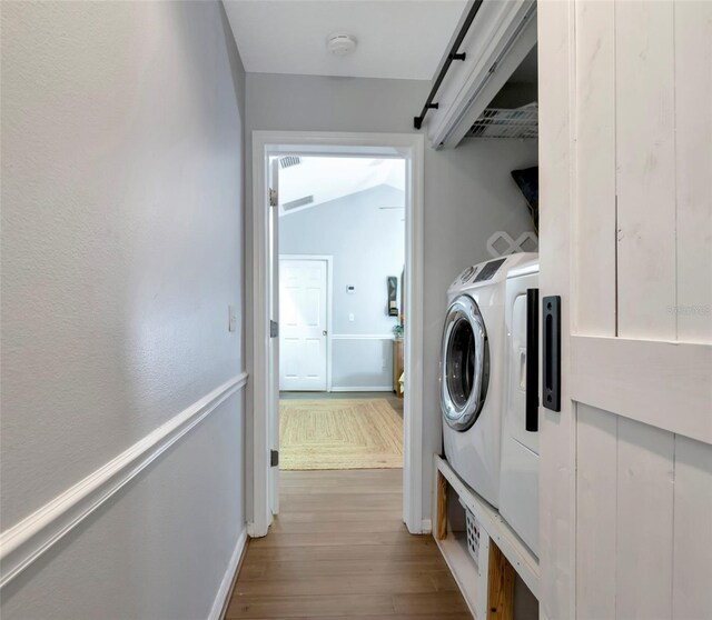 2311 64th Street Ct W, Bradenton, FL 34209 - washroom featuring separate washer and dryer, wood finished floors, and baseboards
