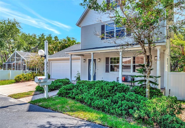 2311 64th Street Ct W, Bradenton, FL 34209 - traditional home with driveway, a garage, and covered porch