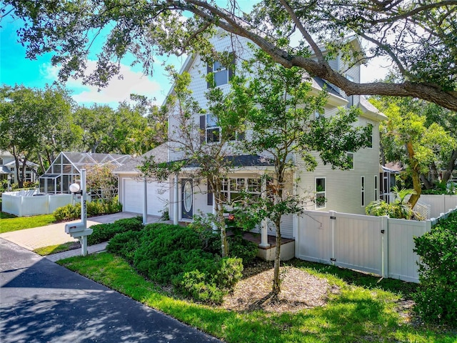 2311 64th Street Ct W, Bradenton, FL 34209 - view of property hidden behind natural elements with a garage and a gate